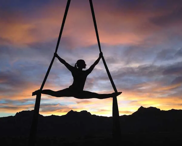 Girl Hanging In Ropes With Sunrise